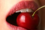 girl bites a cherry